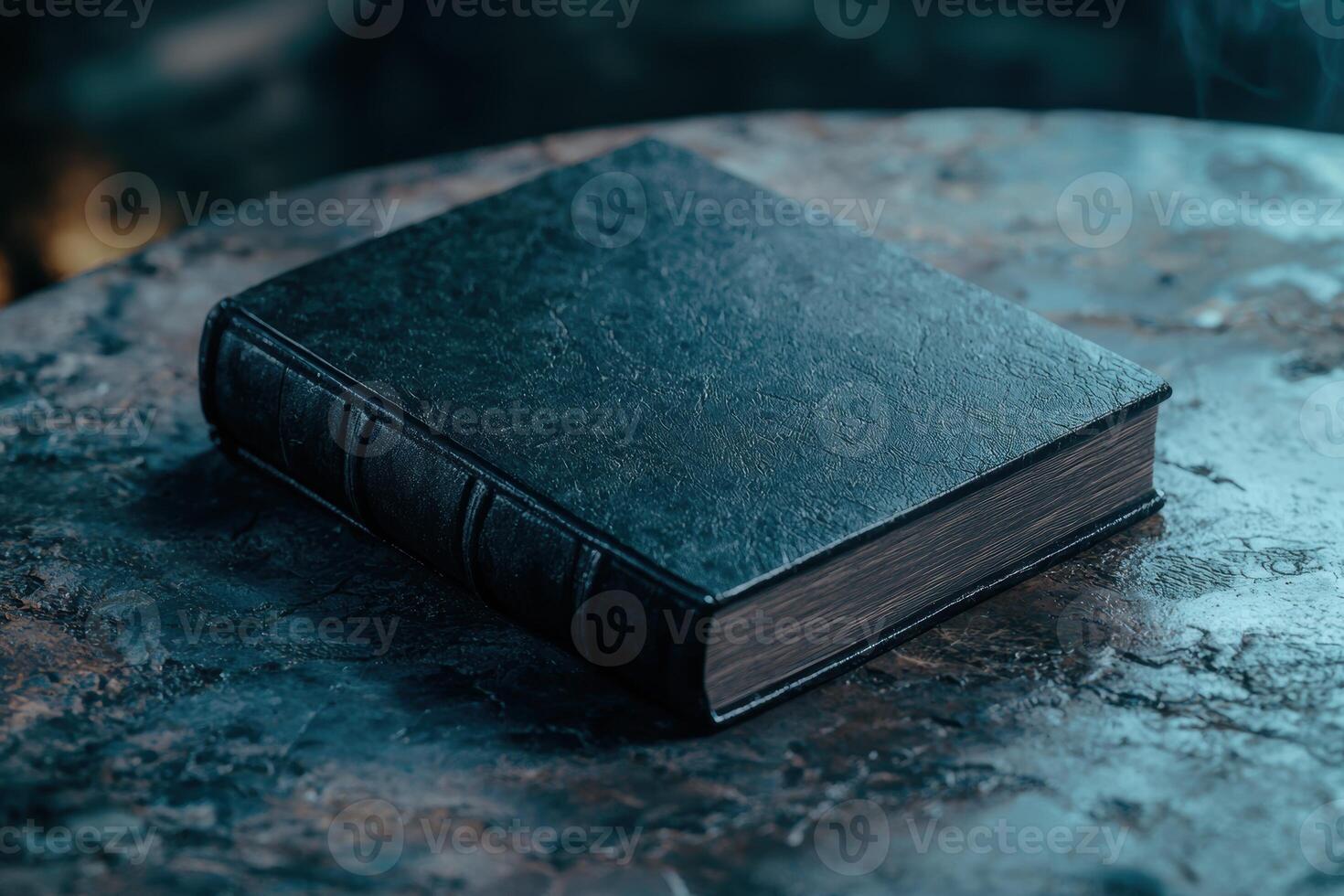 Antique leather bound book on dark marble surface photo