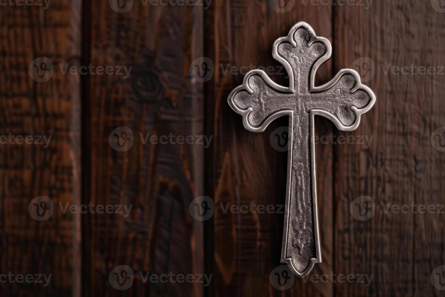 ornate cross on wooden background photo