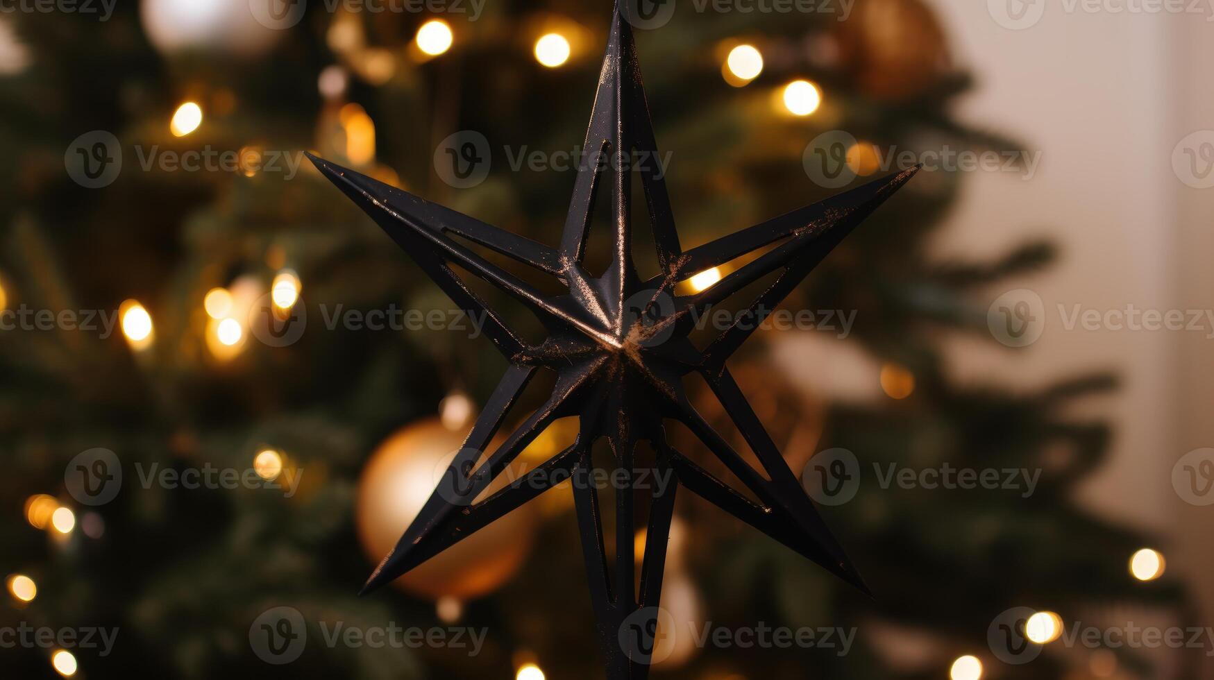 Sparkling star ornament on a christmas tree photo