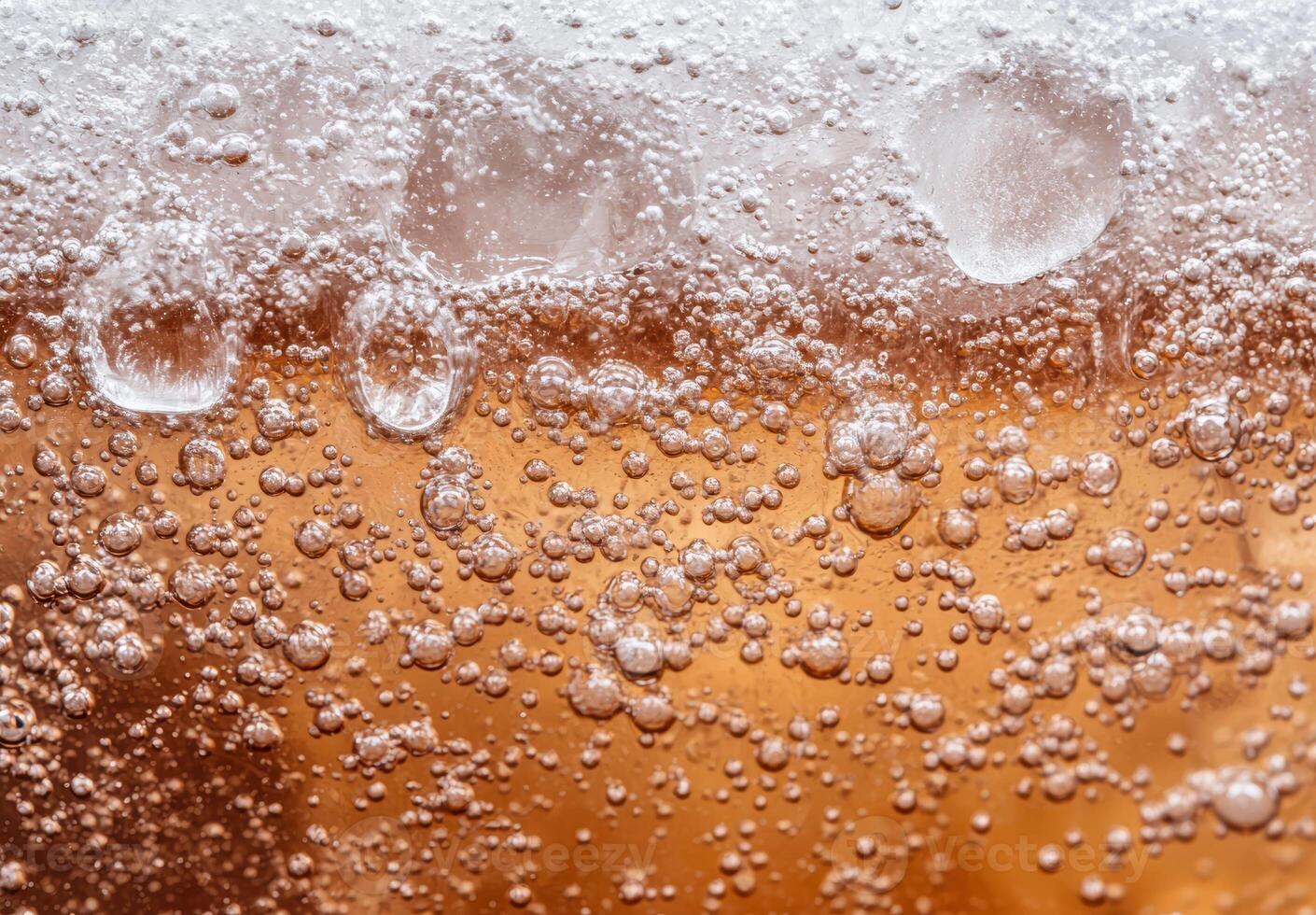 Closeup of fizzing and bubbling beer or soda photo