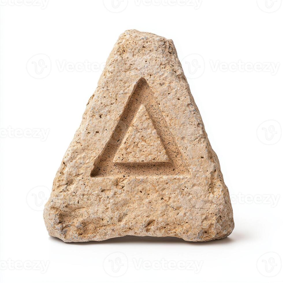 Carved stone triangle symbol on white background photo