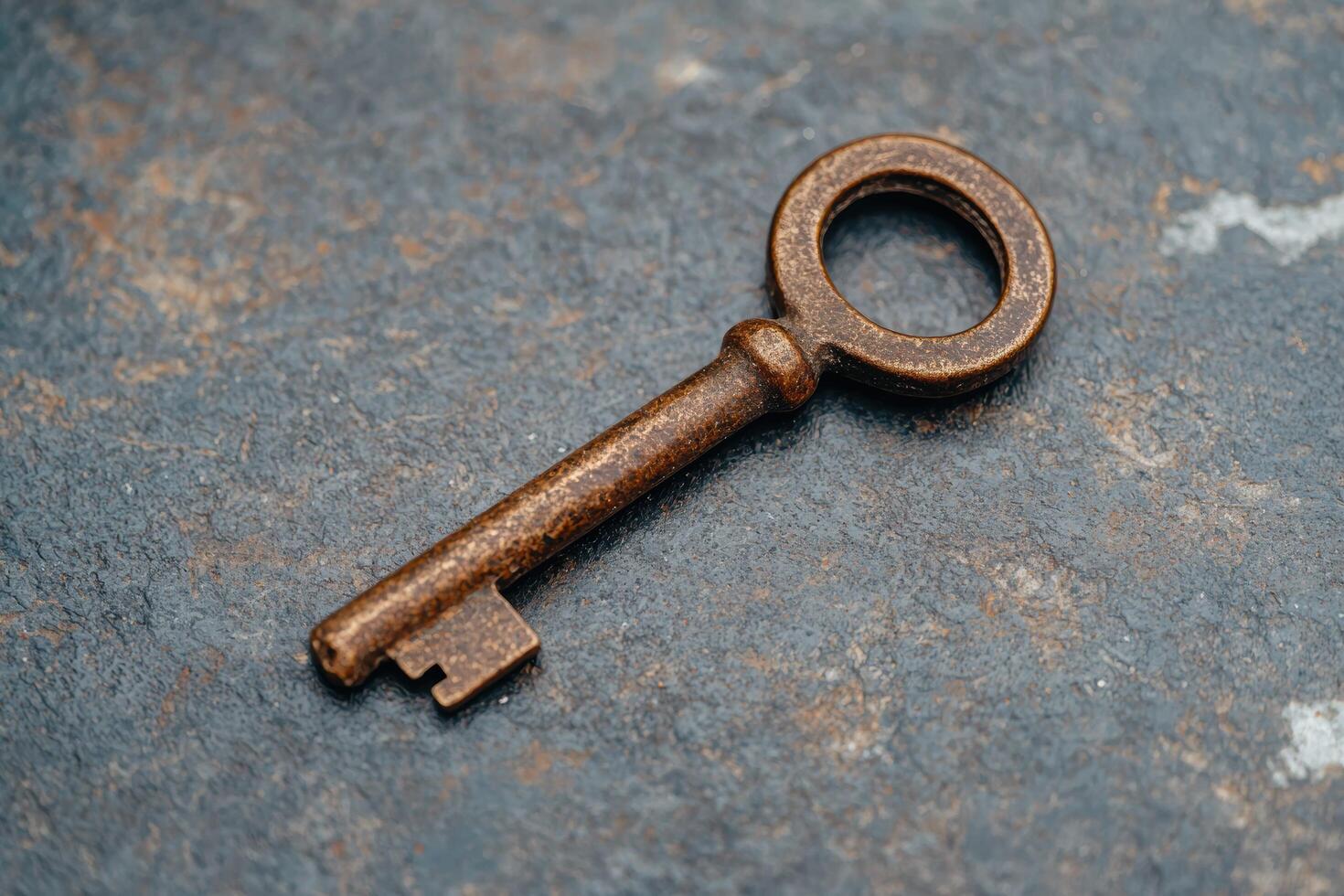 Rusty old key on a weathered surface photo