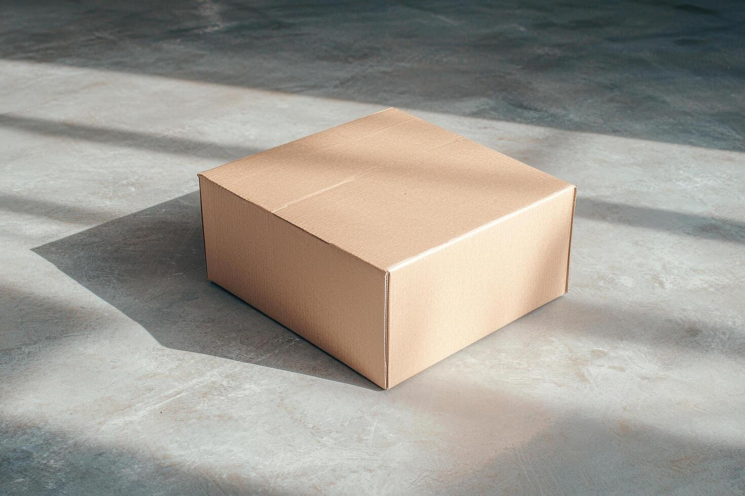 Cardboard box on concrete floor photo