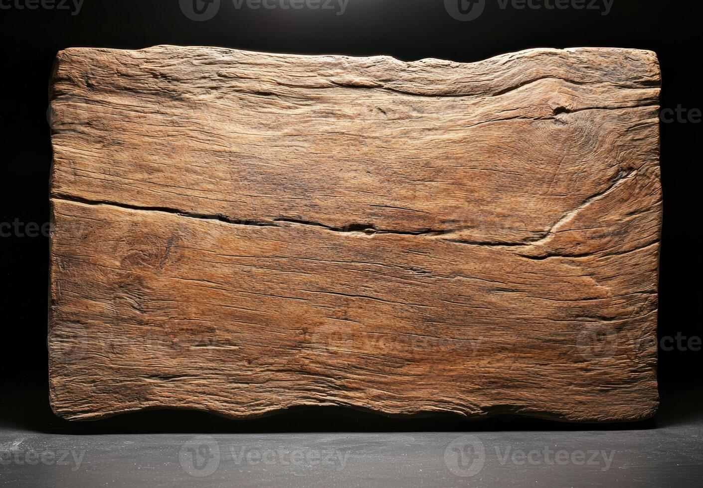 Weathered wooden plank on dark background photo