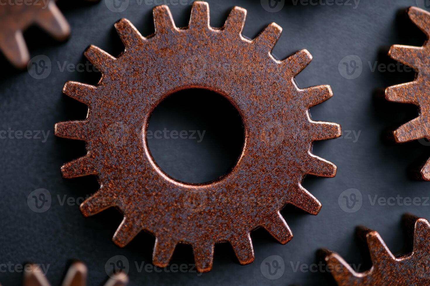 Rusty industrial gear on dark background photo