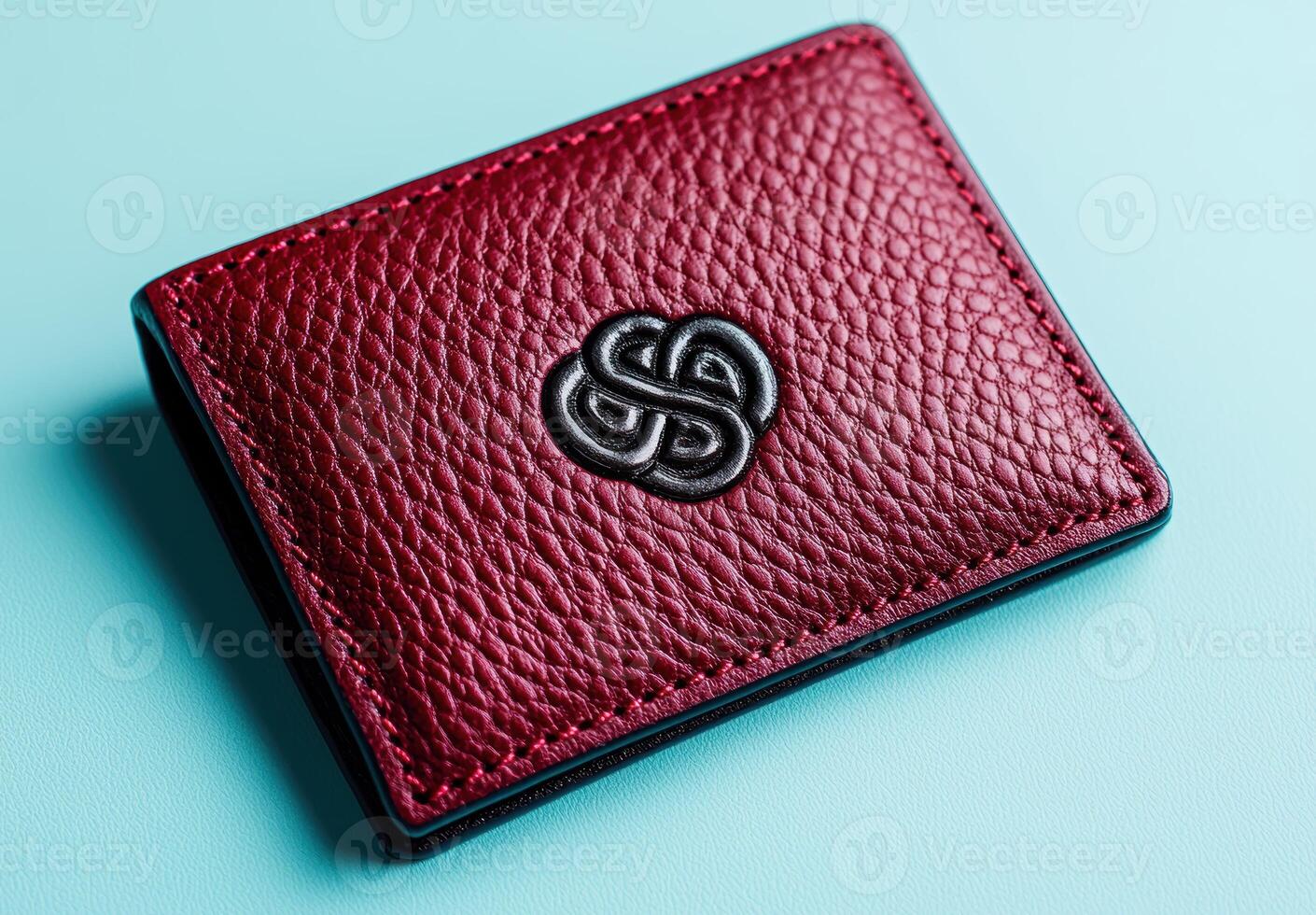 Closeup of a red leather wallet with a stylized logo photo