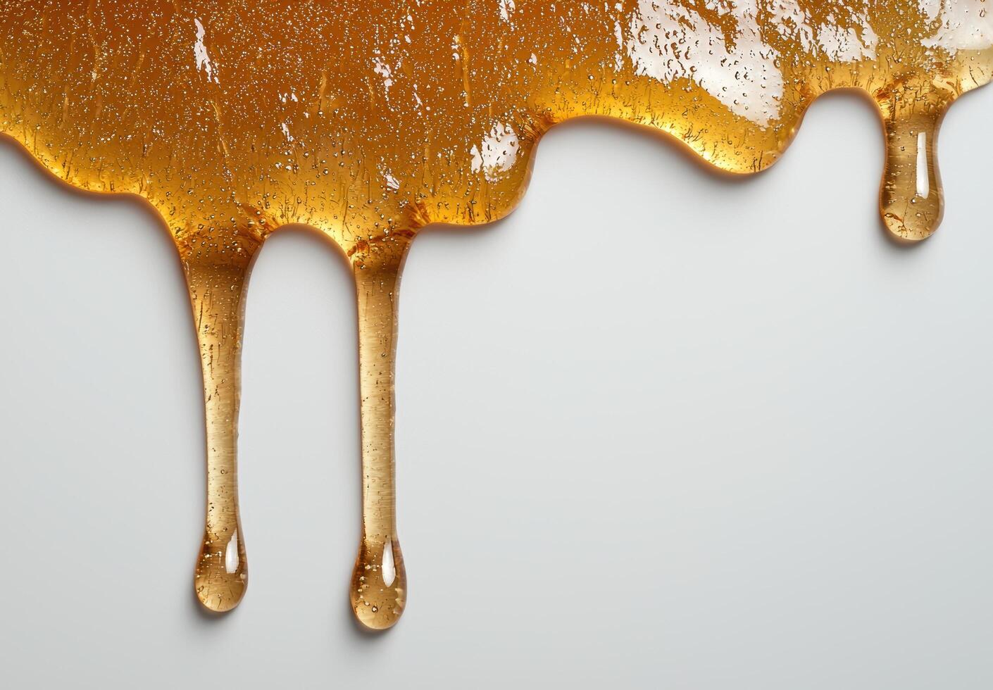 Dripping golden honey on white background photo