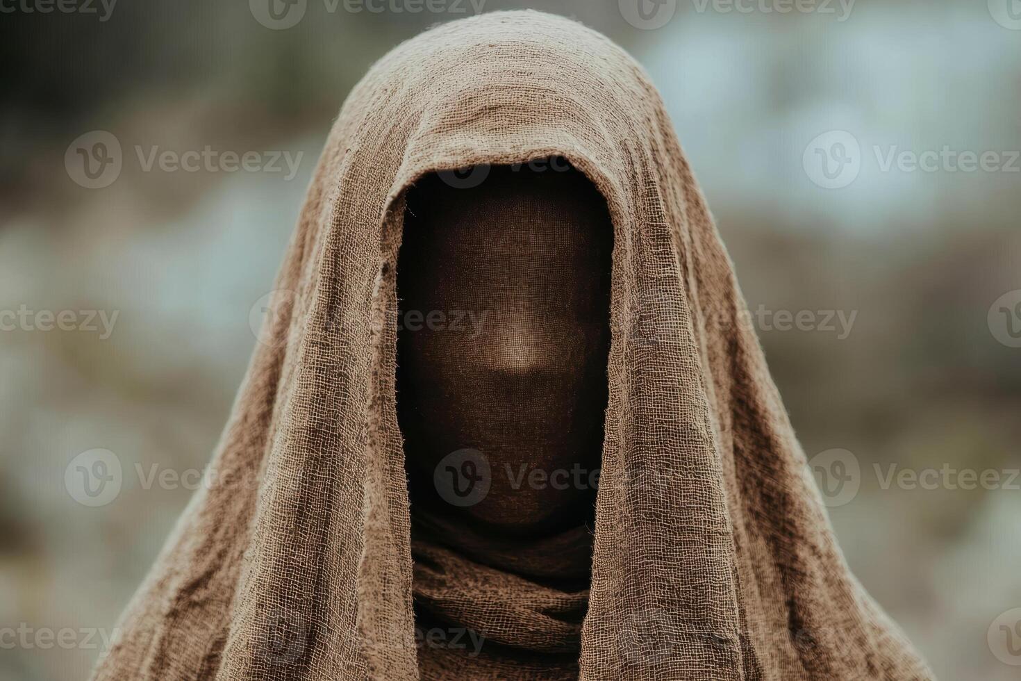 Mysterious hooded figure in the mist photo