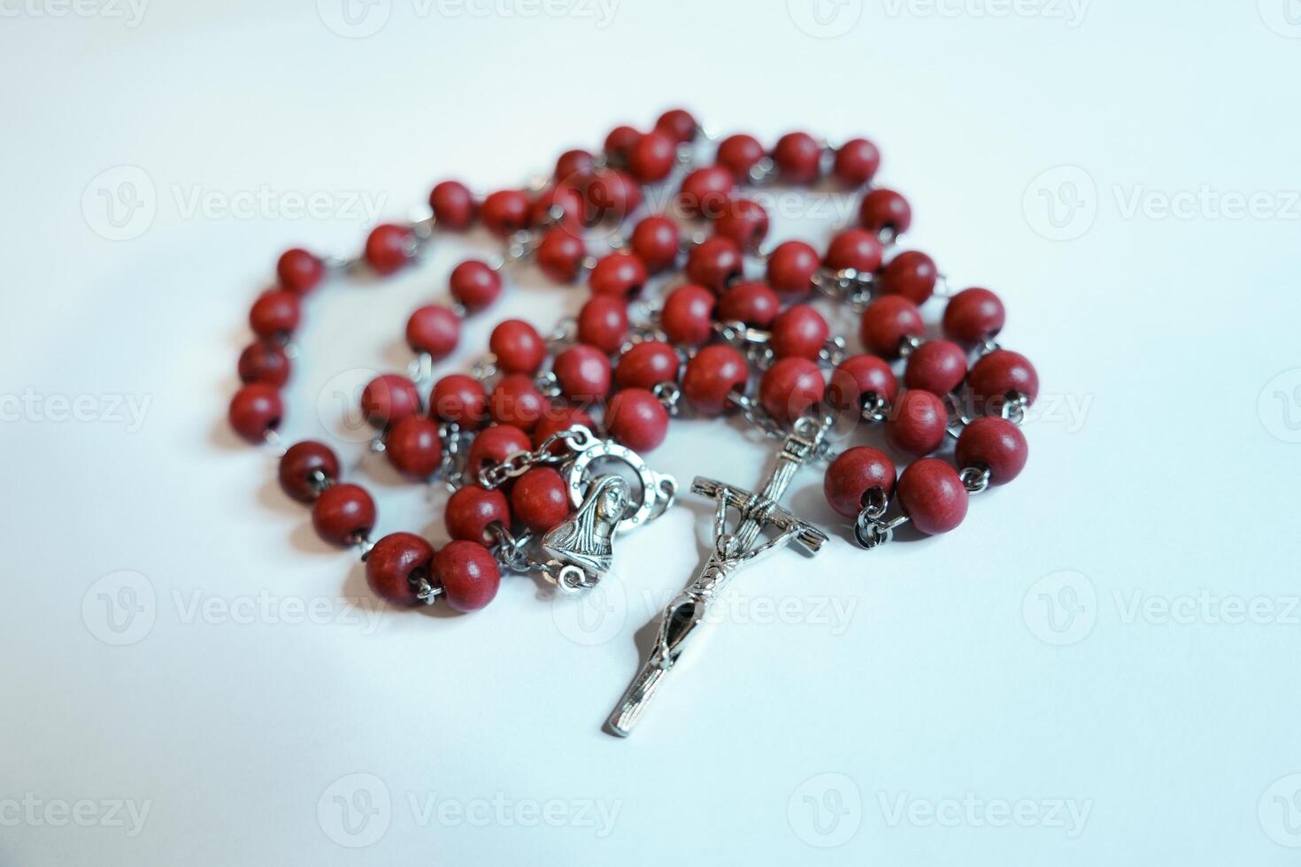 Red rosary on plain background photo