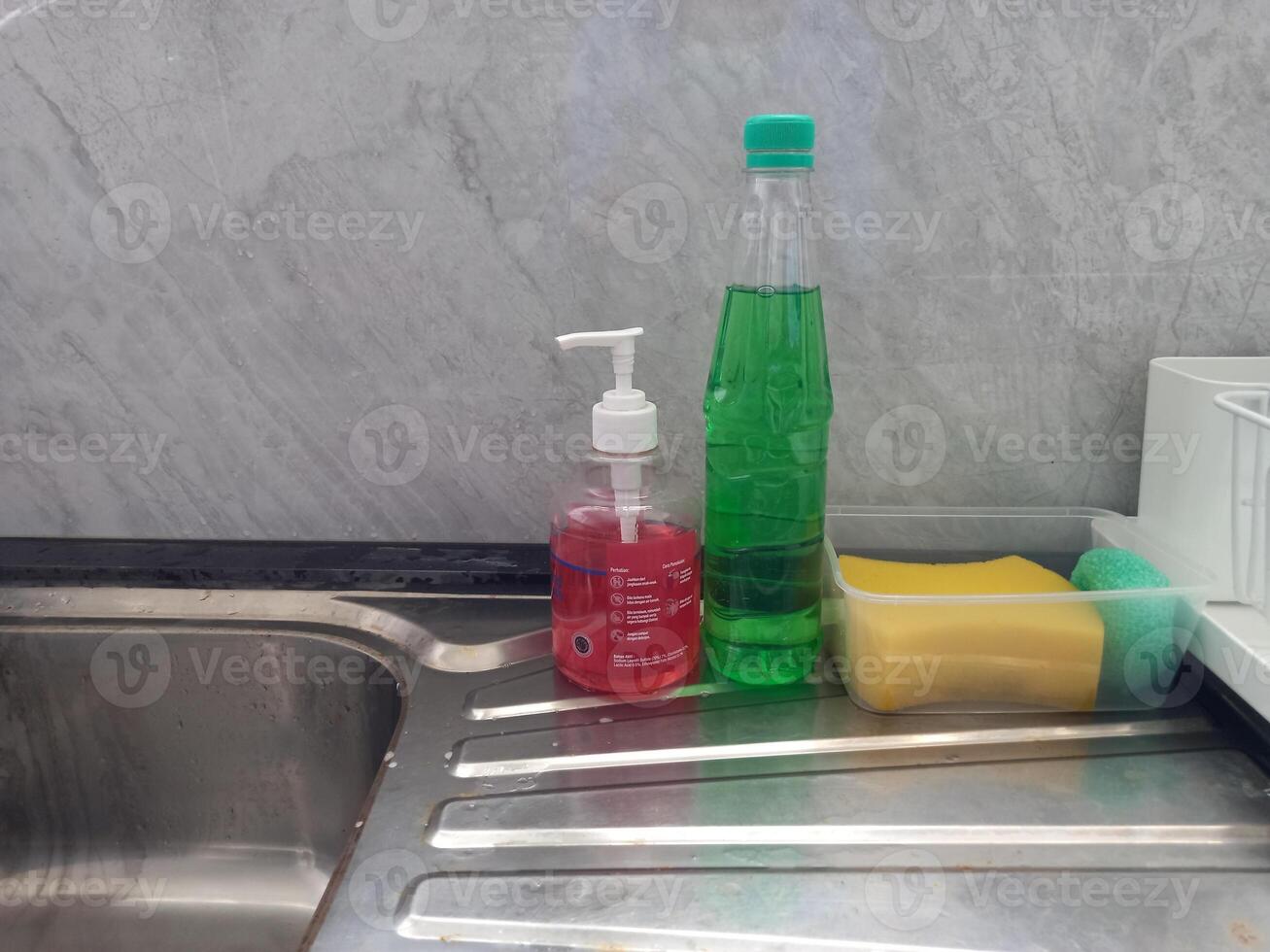 photo of dish soap and dishwashing sponge in the sink