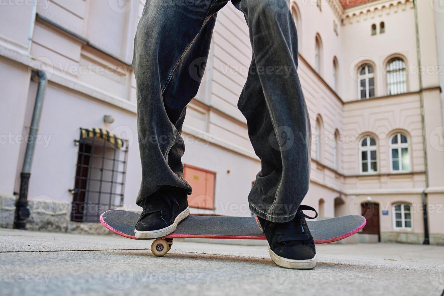 Skateboarder doing trick at urban street photo