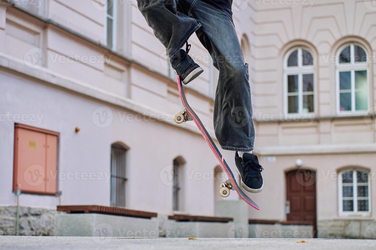 Skateboarder Performing Trick on Urban Street photo
