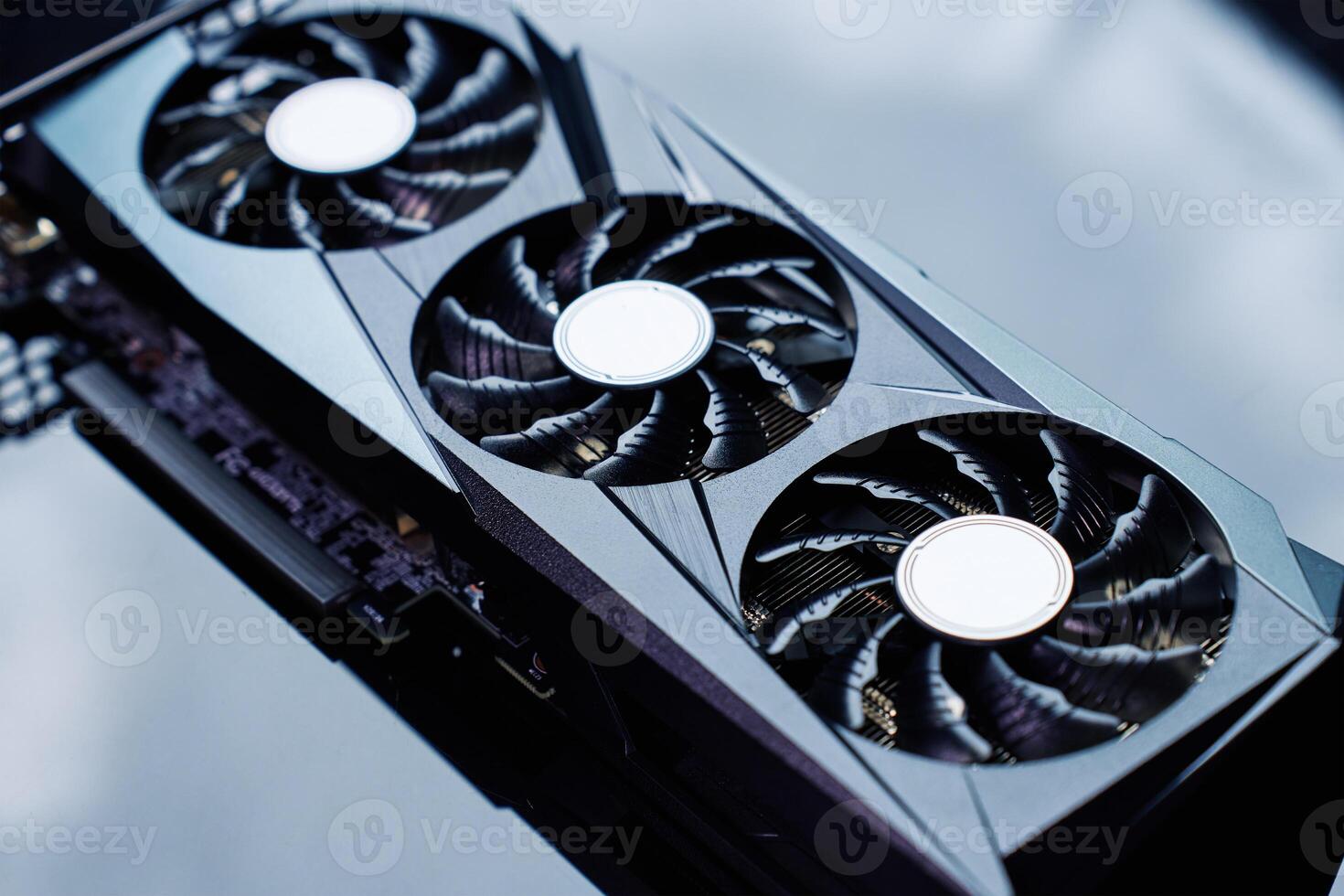 High-end graphics card with triple fan cooling on dark background photo