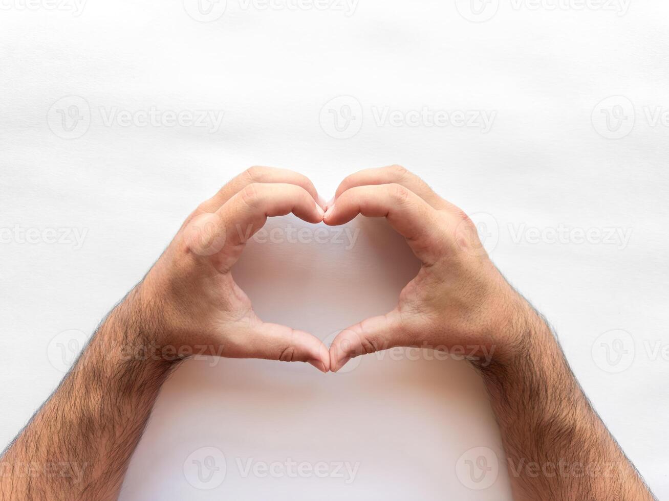 Hands forming heart symbol on white background photo