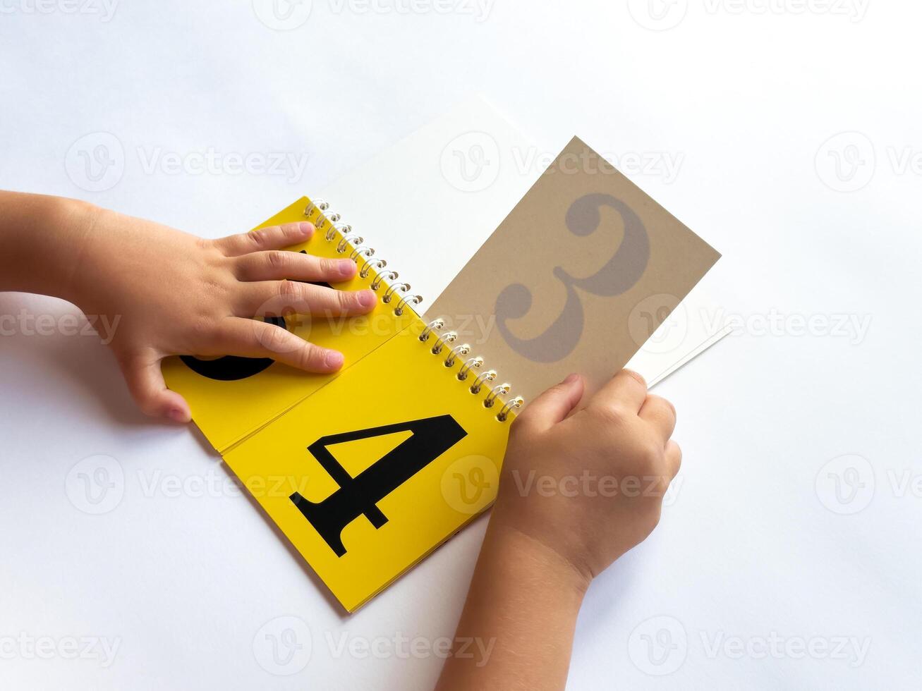 Child learning numbers with a colorful educational flip book photo