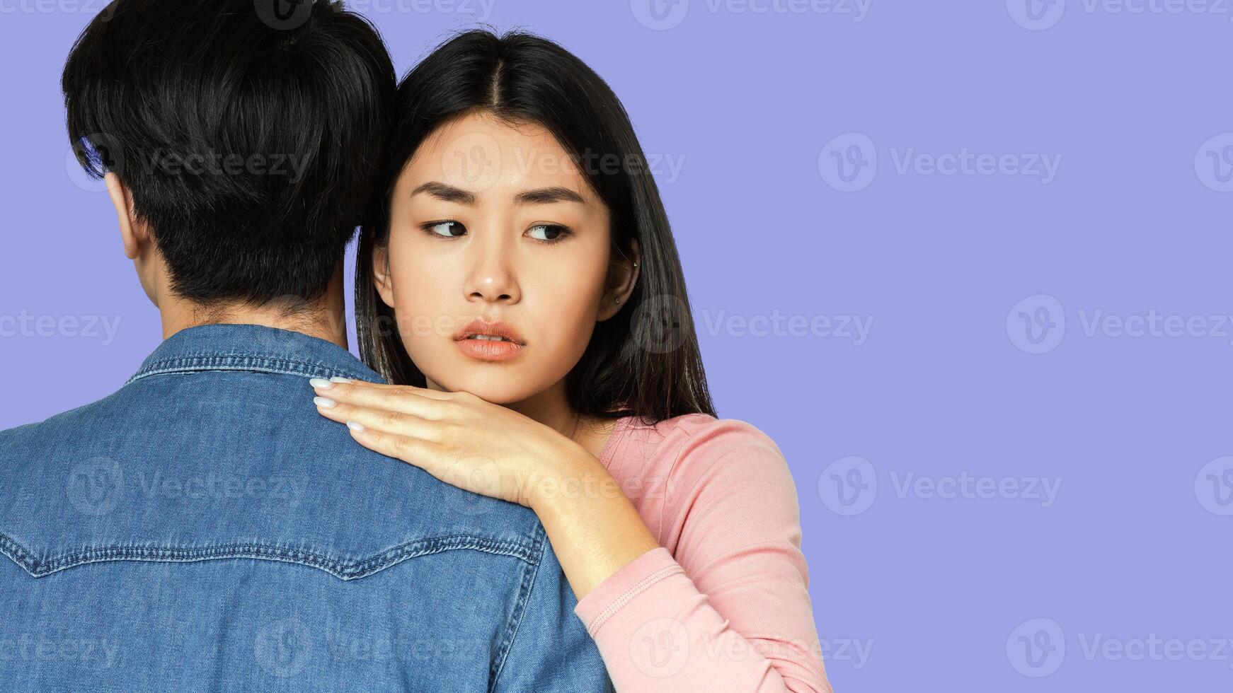 I am afraid. Close up of scared asian girl hugging her boyfriend over grey background, panorama with copy space photo