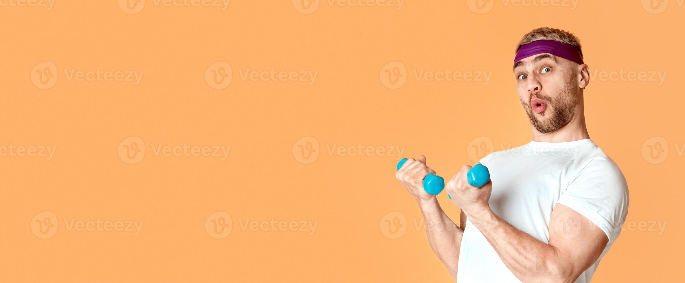 Emotional man blowing lips and funny engaged with small dumbbells, panorama photo