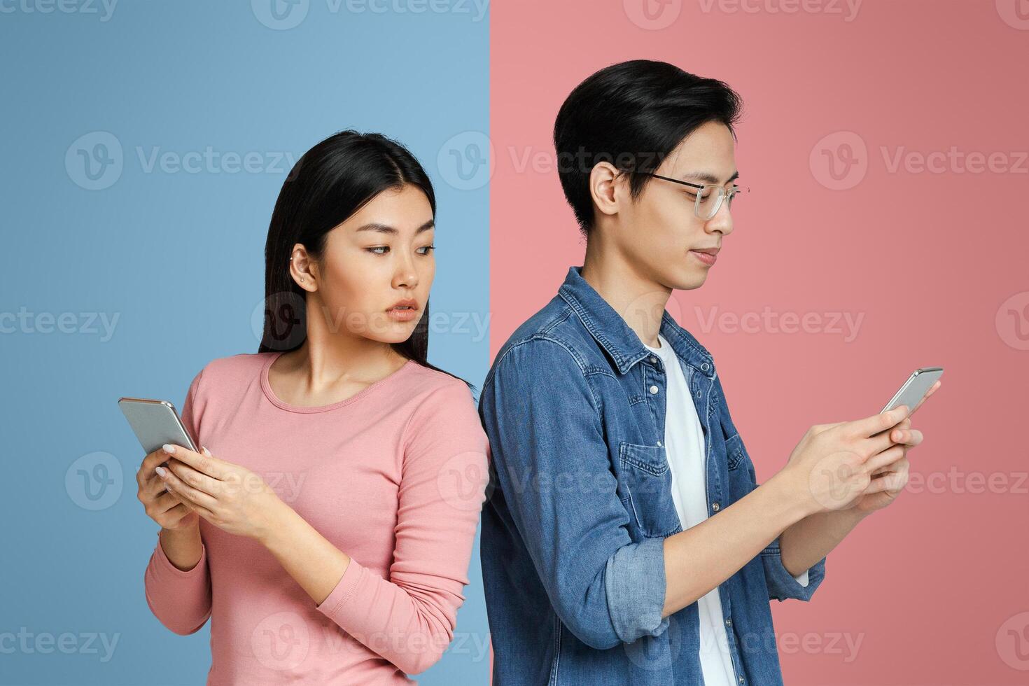 Asian girl spying on her boyfriend while he using mobile phone, trust in relationships photo