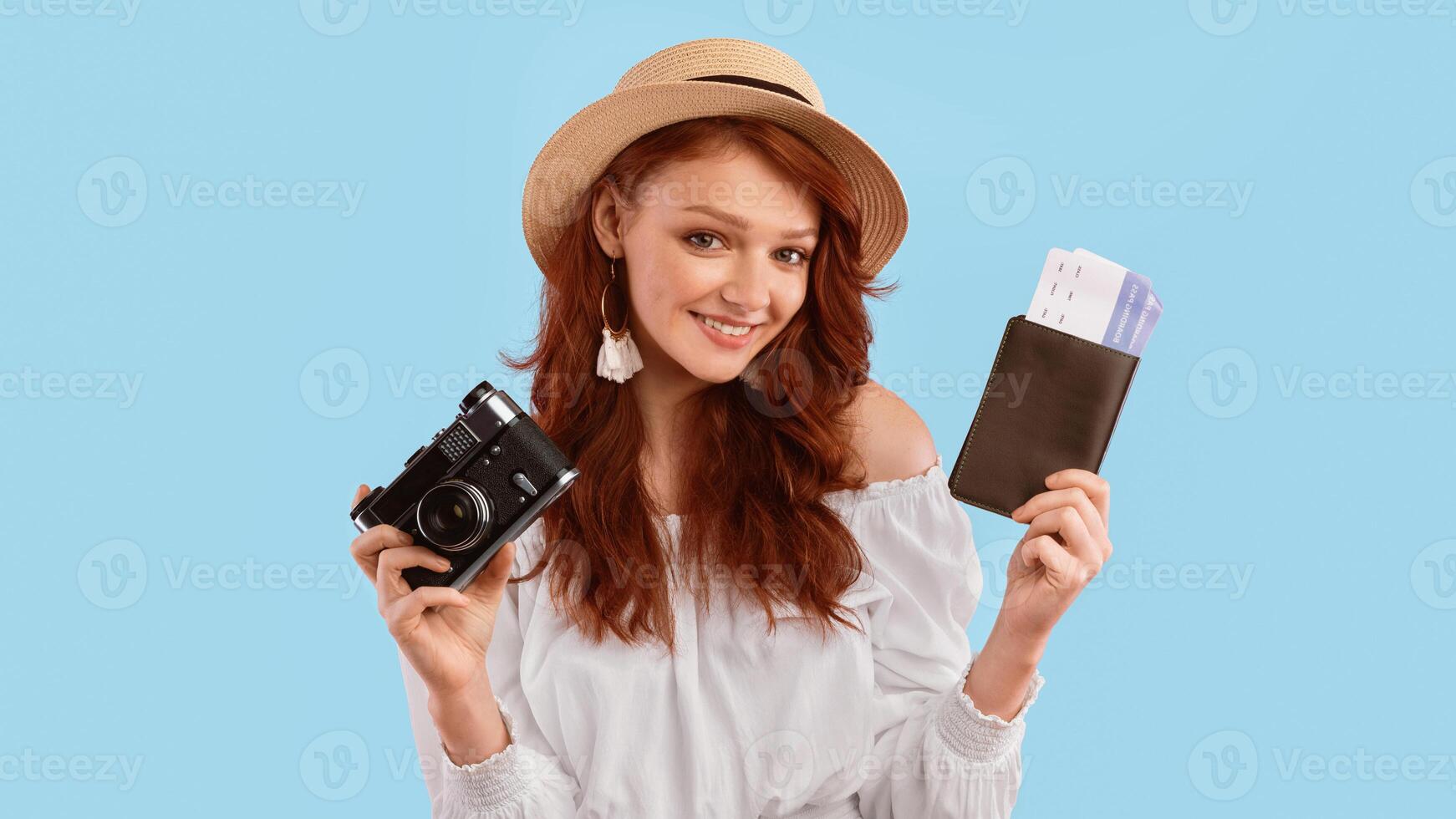 Vacation Concept. Cute Traveler Girl Holding Flight Tickets And Photo Camera, Wearing Summer Hat Posing On Pink Studio Background. Panorama