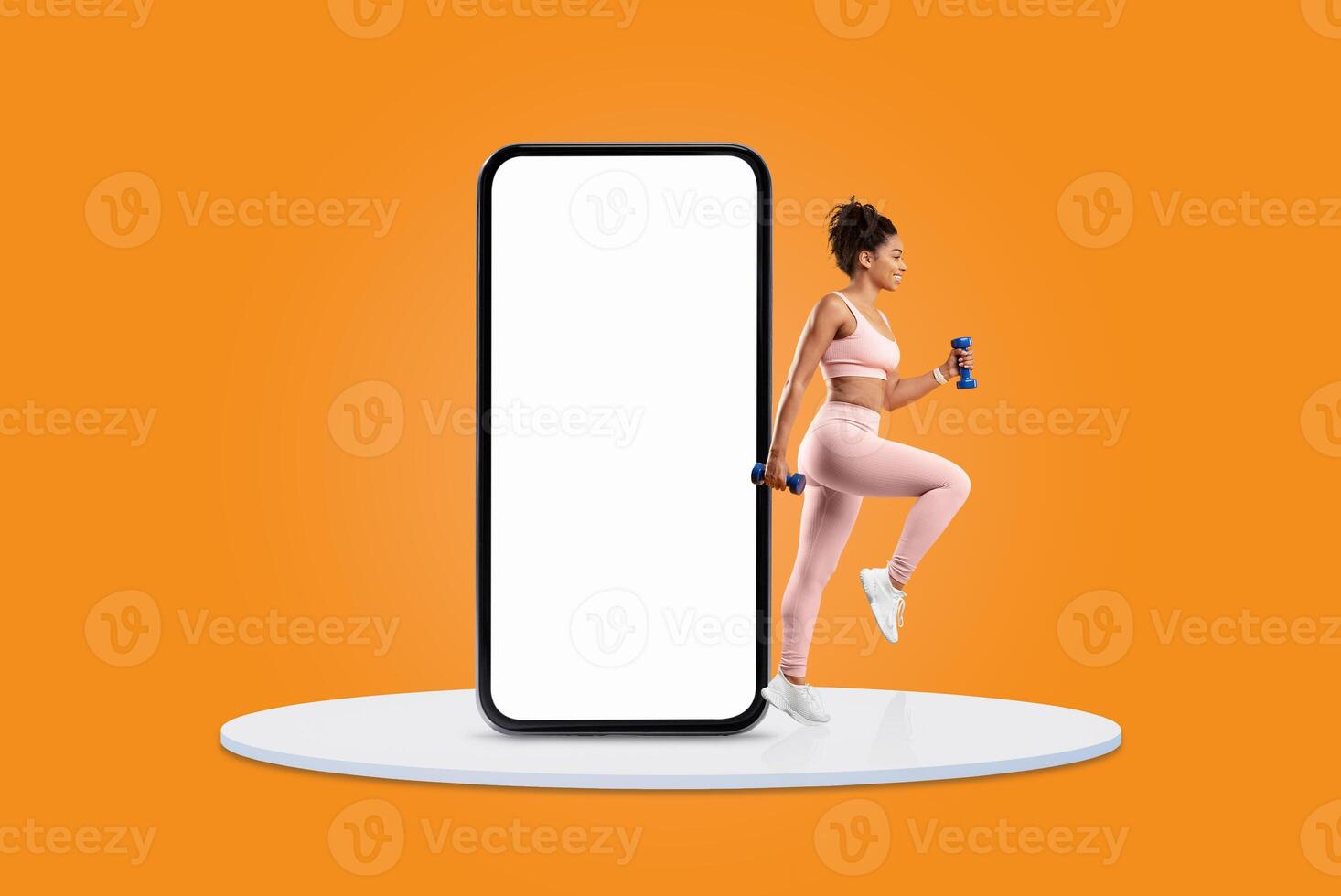 A woman wearing athletic clothing engages in an exercise routine while holding dumbbells, positioned next to a large smartphone outline on a vibrant orange background. photo