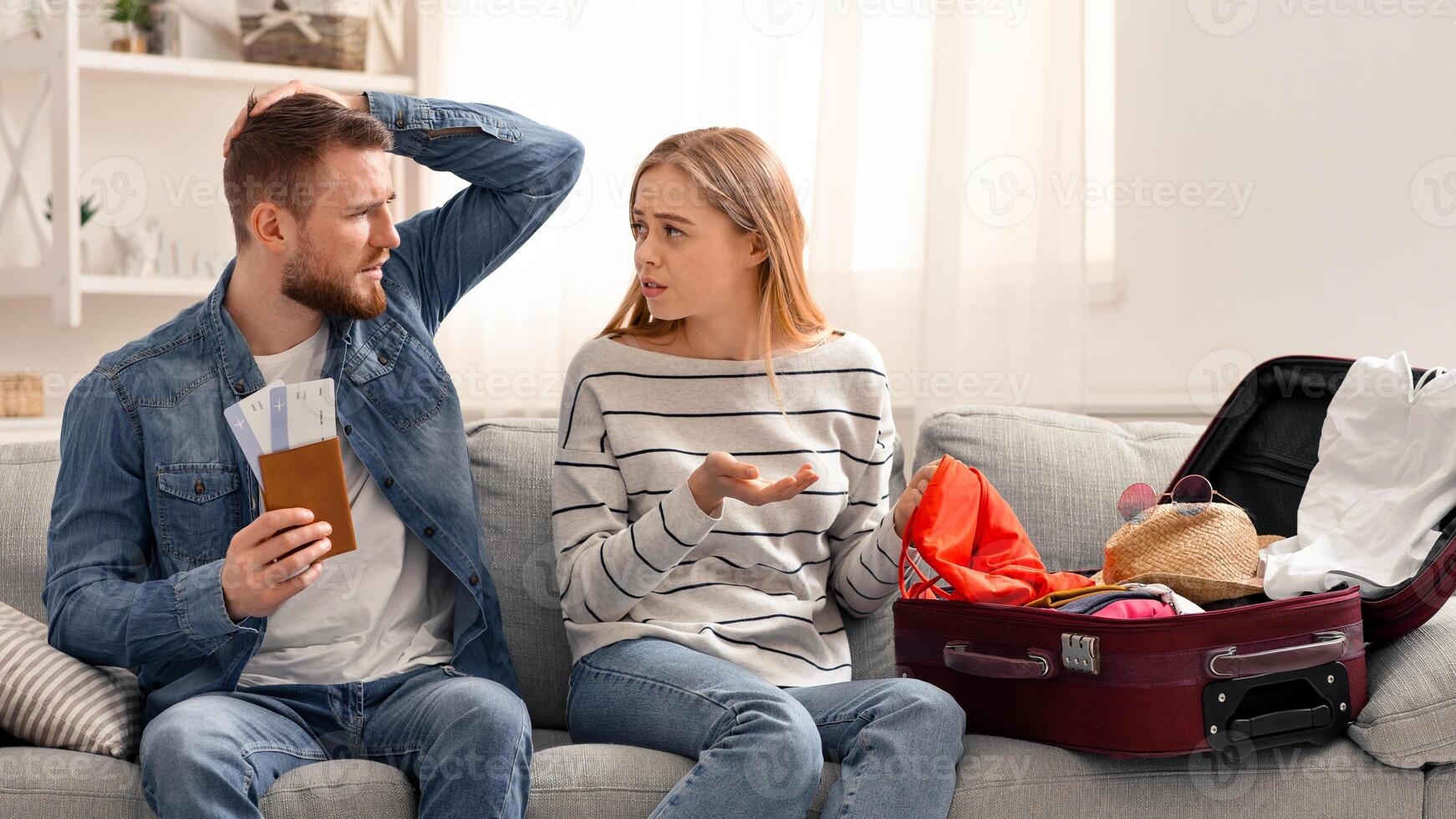 Failed vacation. Upset couple with flight tickets unpacking suitcase at home, free space photo