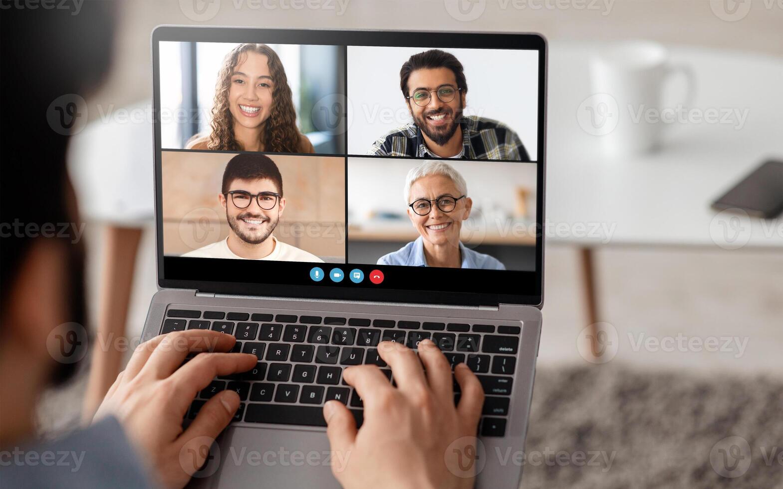 Four friends are enjoying a lively call, smiling and engaging with each other. The setting is relaxed, with a cozy background and a focus on their friendly conversation. photo