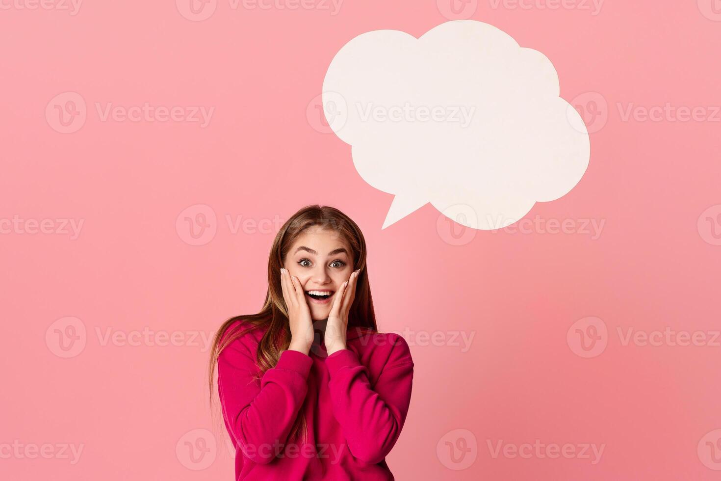 Happy teenage girl with thinking cloud isolated on pink background photo