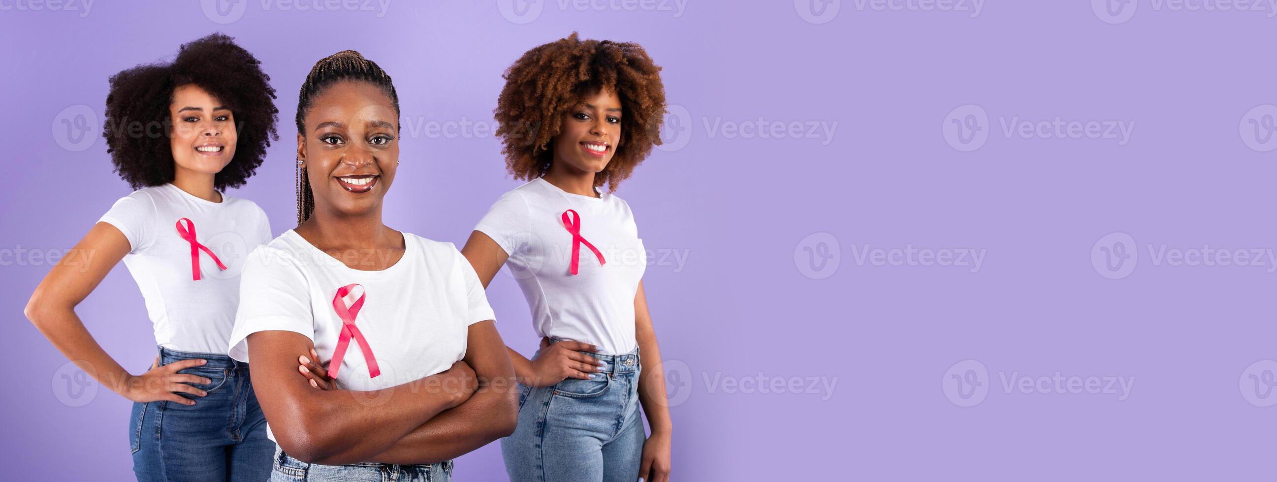 Breast Cancer Awareness Advertisement. Group Of Three African American Ladies With Pink Ribbons Over Purple Background, Studio Shot, Selective Focus. Oncology Nursing Month Concept, Copy Space photo
