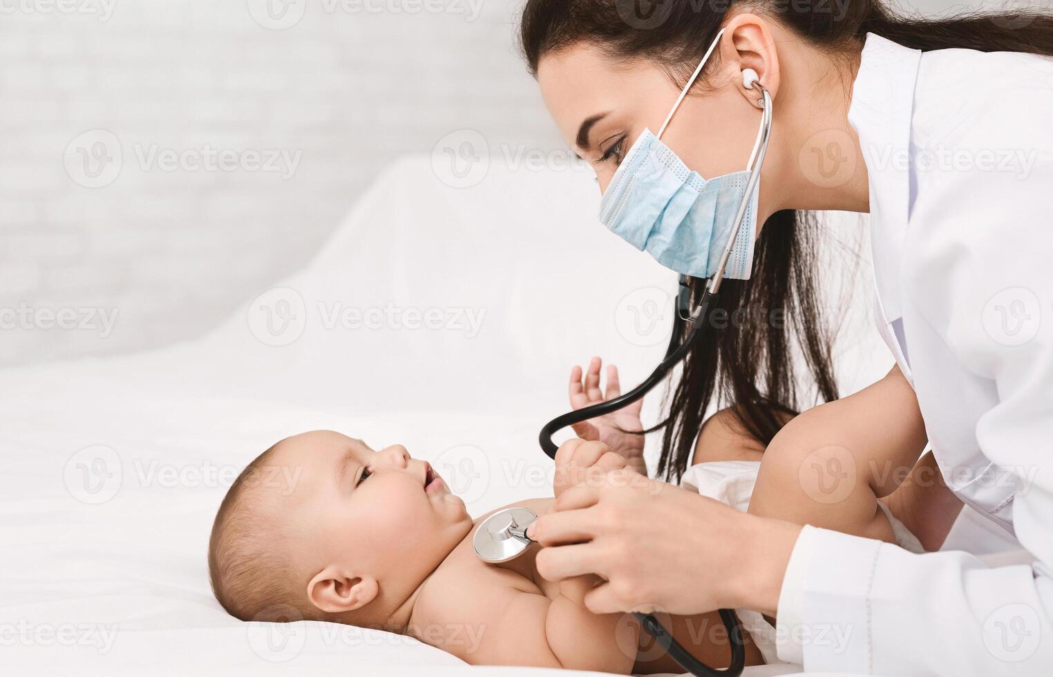 Baby is sick. Pediatrician listening to child breath, examining lungs with stethoscope, free space photo