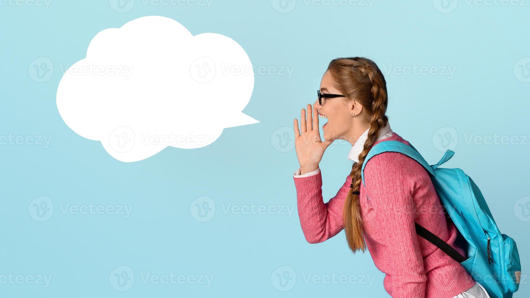 Something interesting at school. Funny girl with backpack screams in abstract place for words, profile, isolated on blue background, studio shot photo