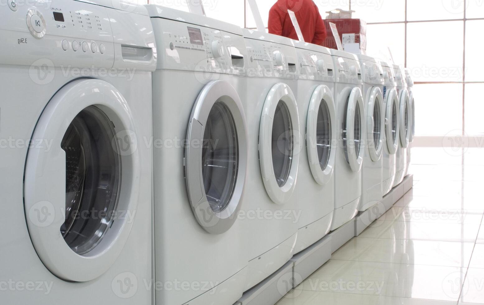 Rows of modern washing machines in a store photo