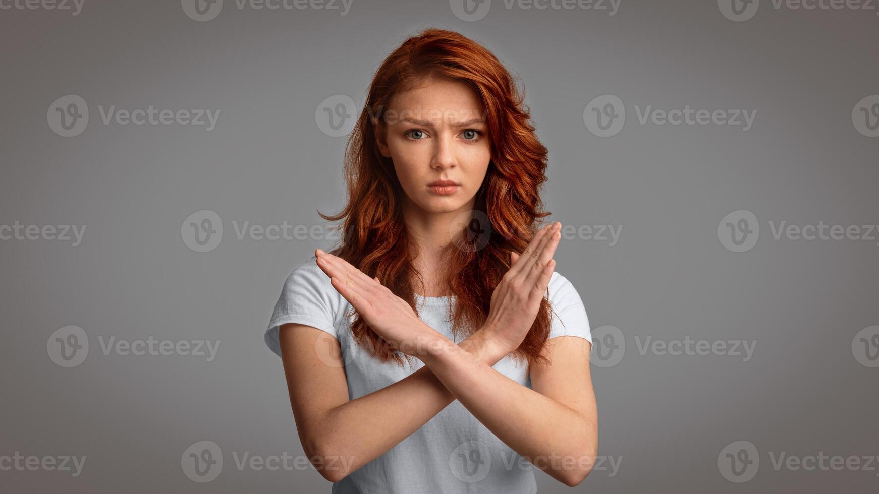 Self-Isolation. Determined Girl Gesturing No Crossing Hands Forbidding Something Posing Over Gray Background. Studio Shot, Panorama photo