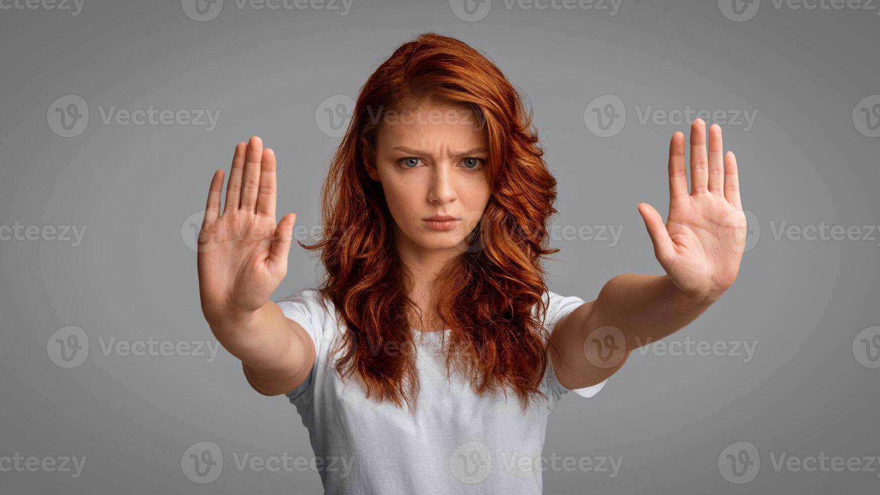 Girl Gesturing Stop With Both Hands Frowning Looking At Camera Posing On Gray Studio Background. No Bullying Concept. Panorama photo