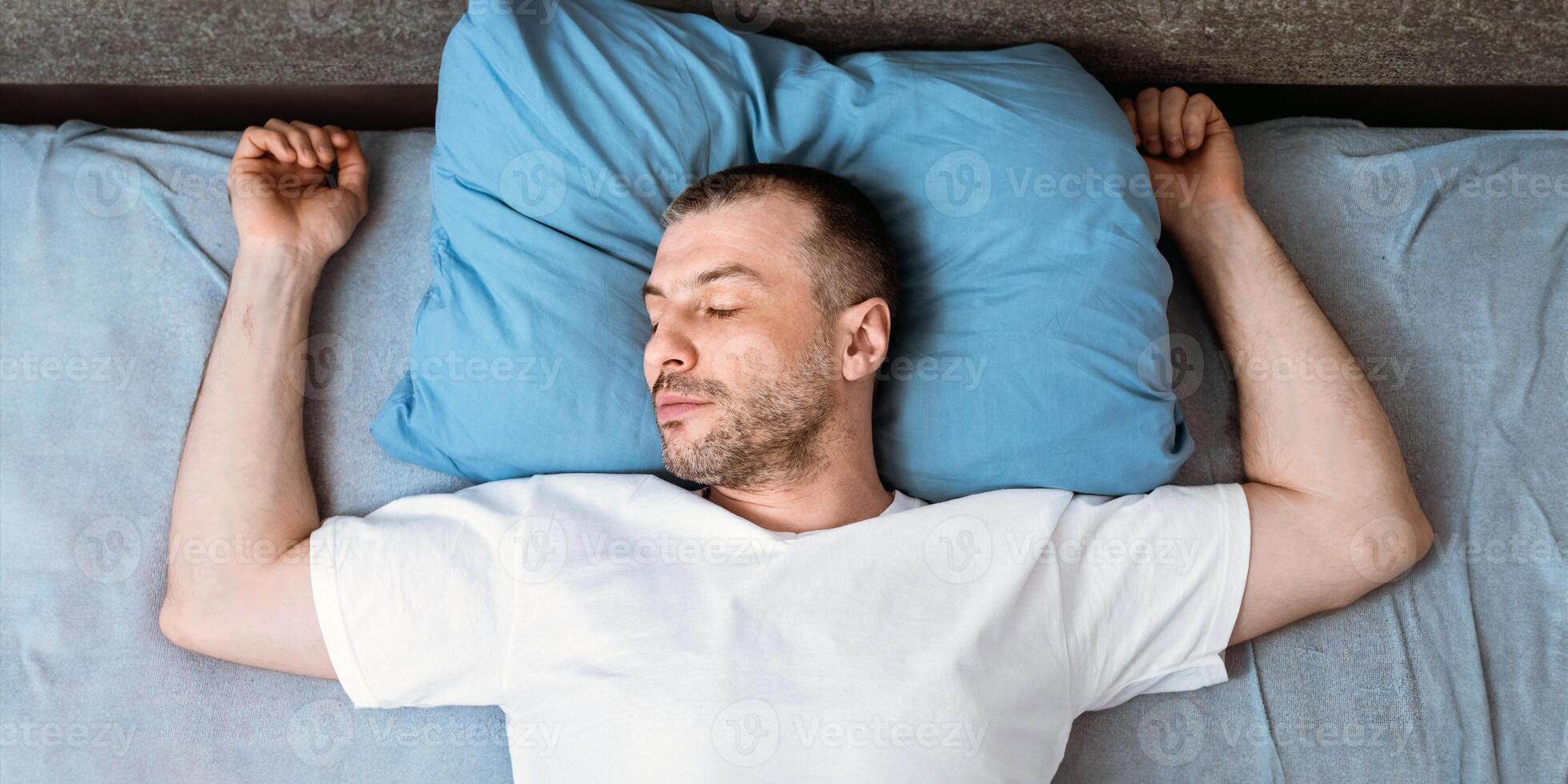 Mature Man Sleeping And Snoring Lying In Bed In Bedroom Staying At Home During Covid-19 Quarantine. Top View, Panorama photo