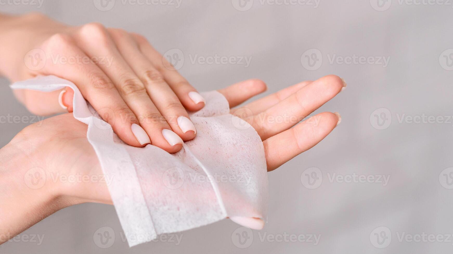 Hygiene during epidemic. Girl wipes hands with antiseptic napkin photo