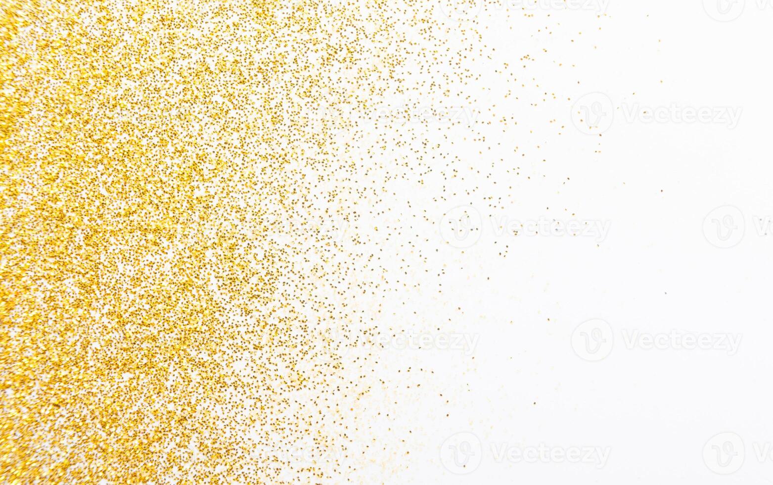 Golden glitter sand texture on white, abstract background. Yellow dusty shimmer decoration, shiny and sparkling frame, top view, copy space. Holidays and glamour concept. photo