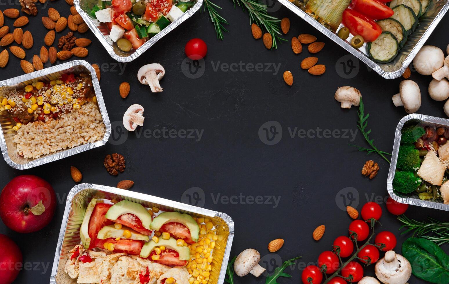 Healthy restaurant food delivery background with copy space. Mockup for menu, foil containers with meals on black photo