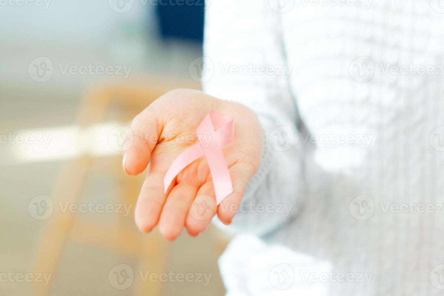 female hands holding AIDS awareness ribbon photo