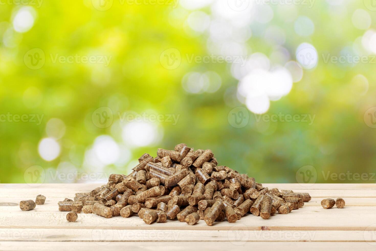 Wood pellets on a green background. Biofuels. photo