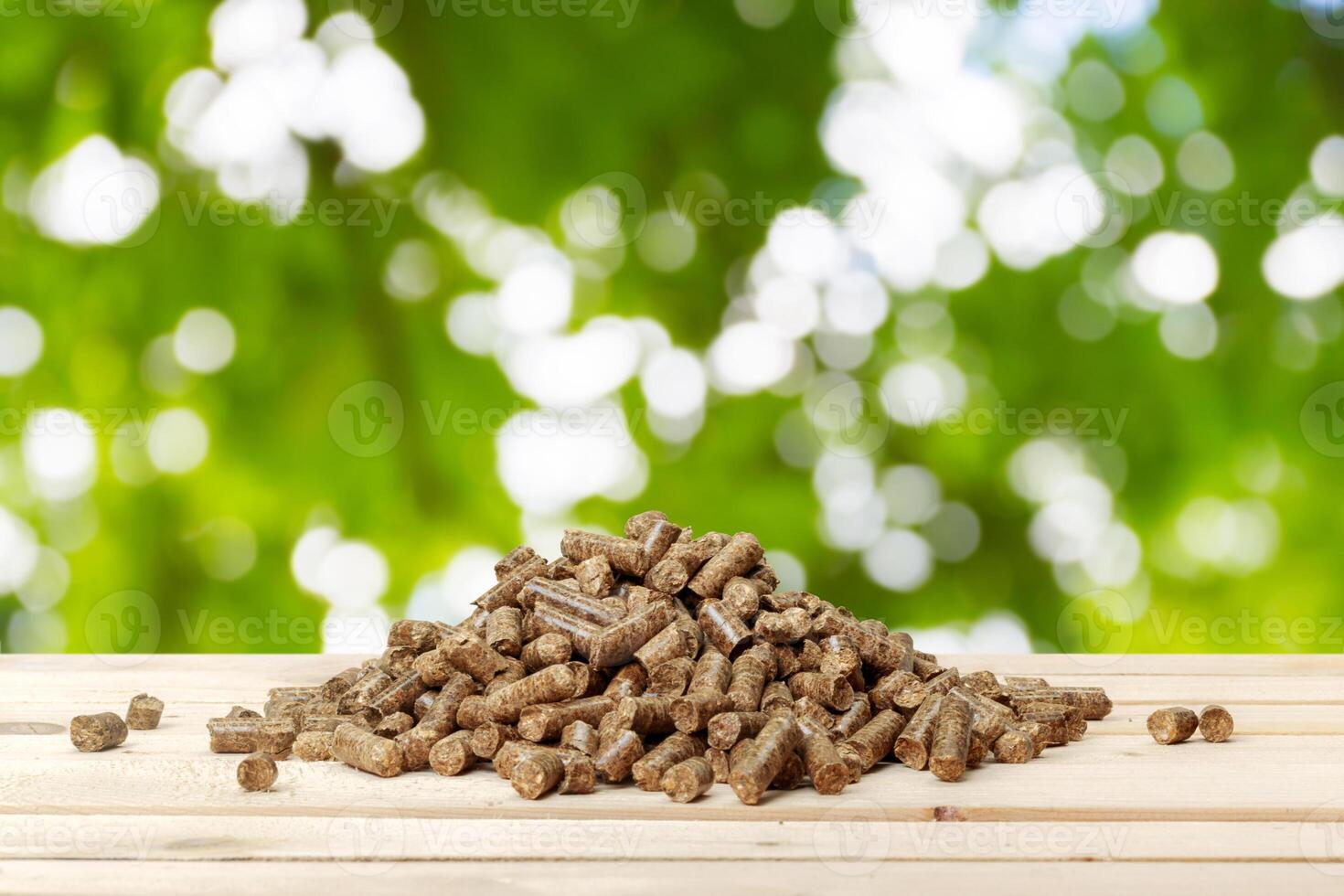 Wood pellets on a green background. Biofuels. photo