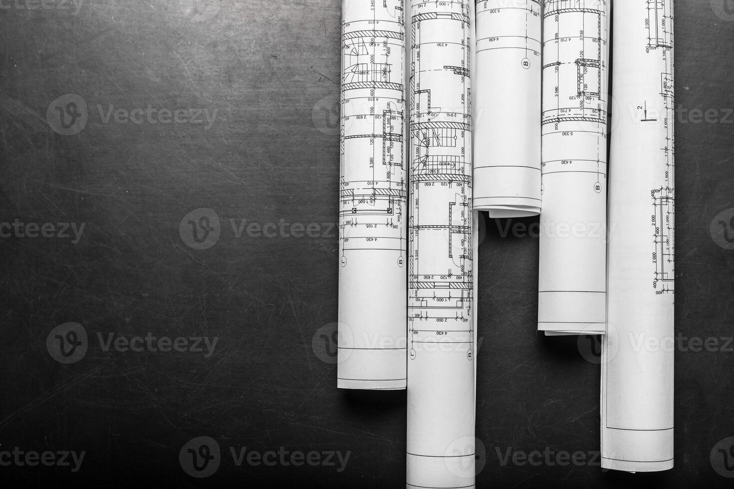 Construction planning drawings on black background photo