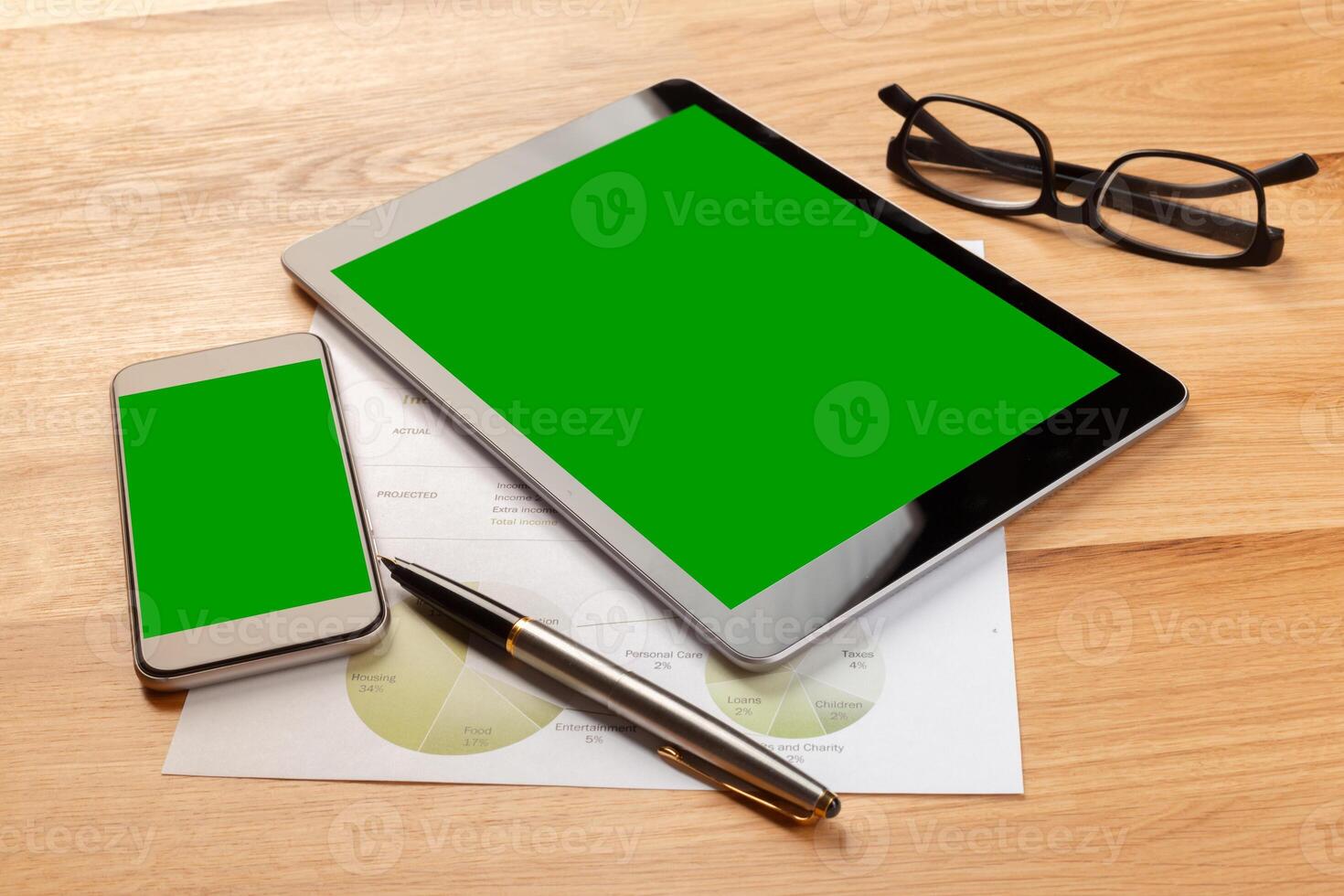 Smartphone and digital tablet on wooden desk photo