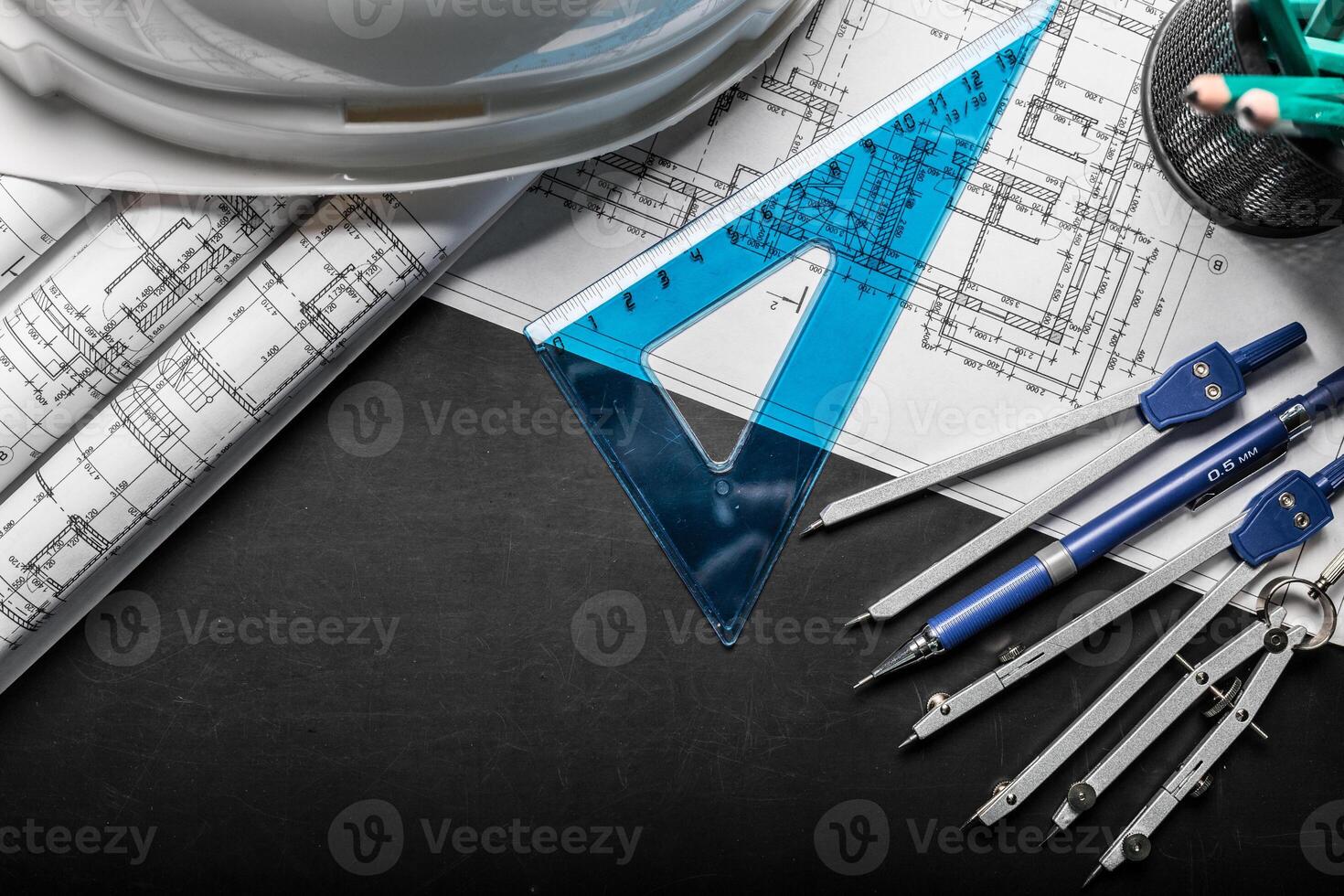 Construction planning drawings on black background photo