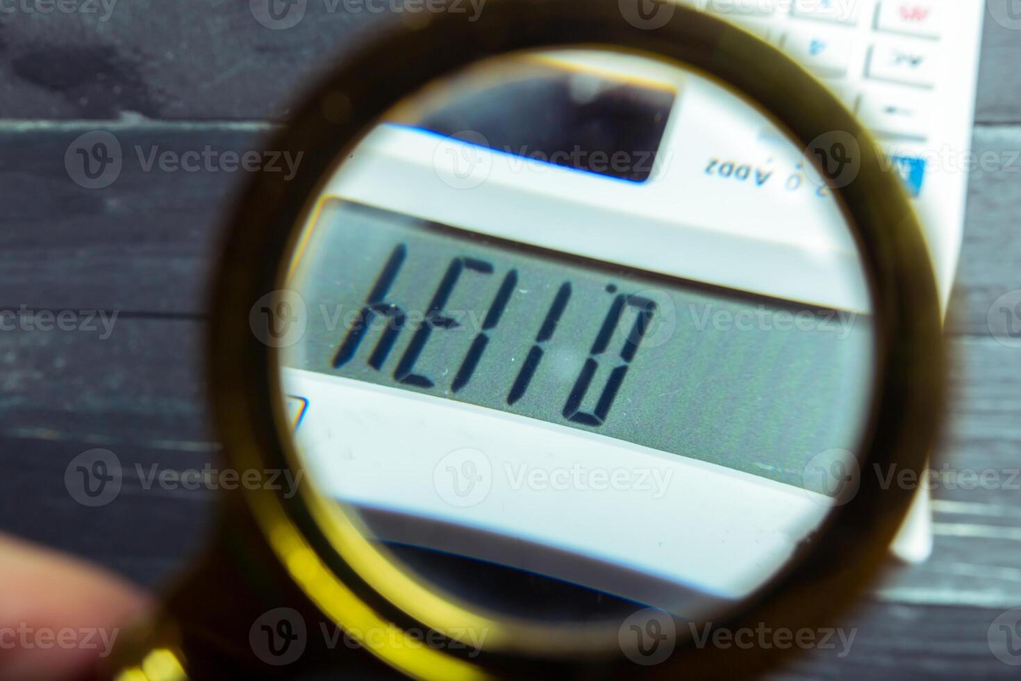 Calculator and magnifying glass photo