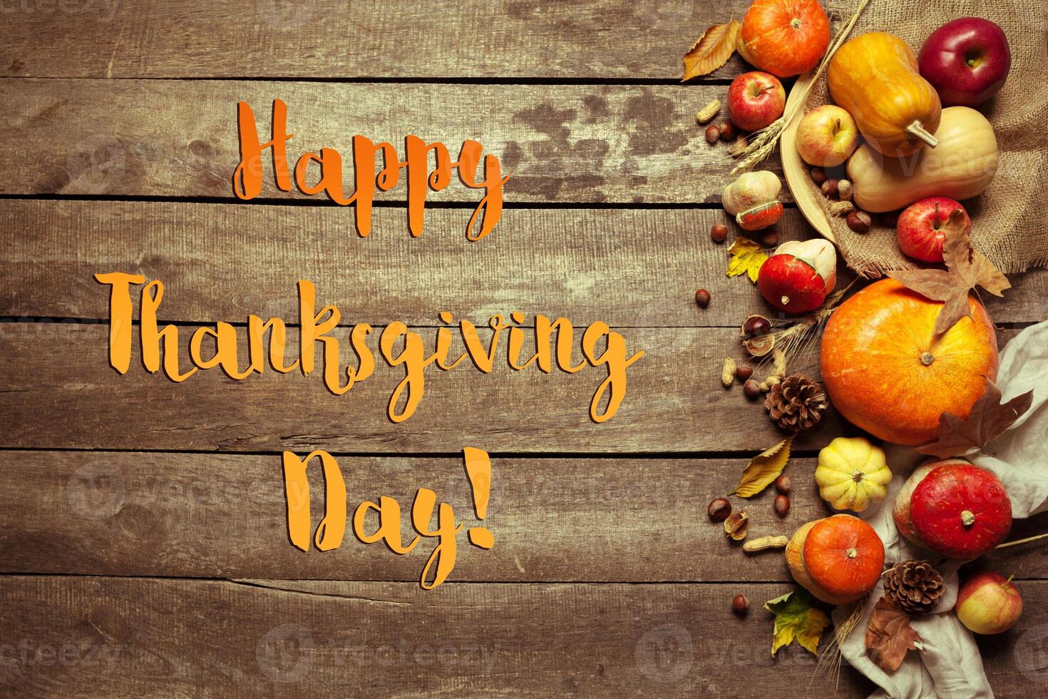 Happy thanksgiving day display on wooden background photo