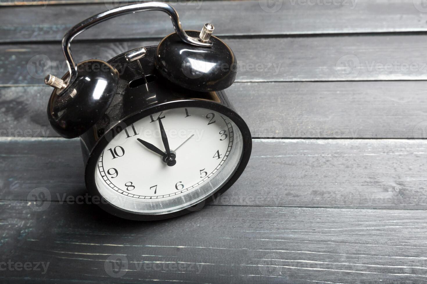 alarm clock on a wooden table photo