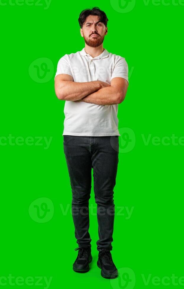 A young man with a beard showing a serious expression against a vibrant green background photo