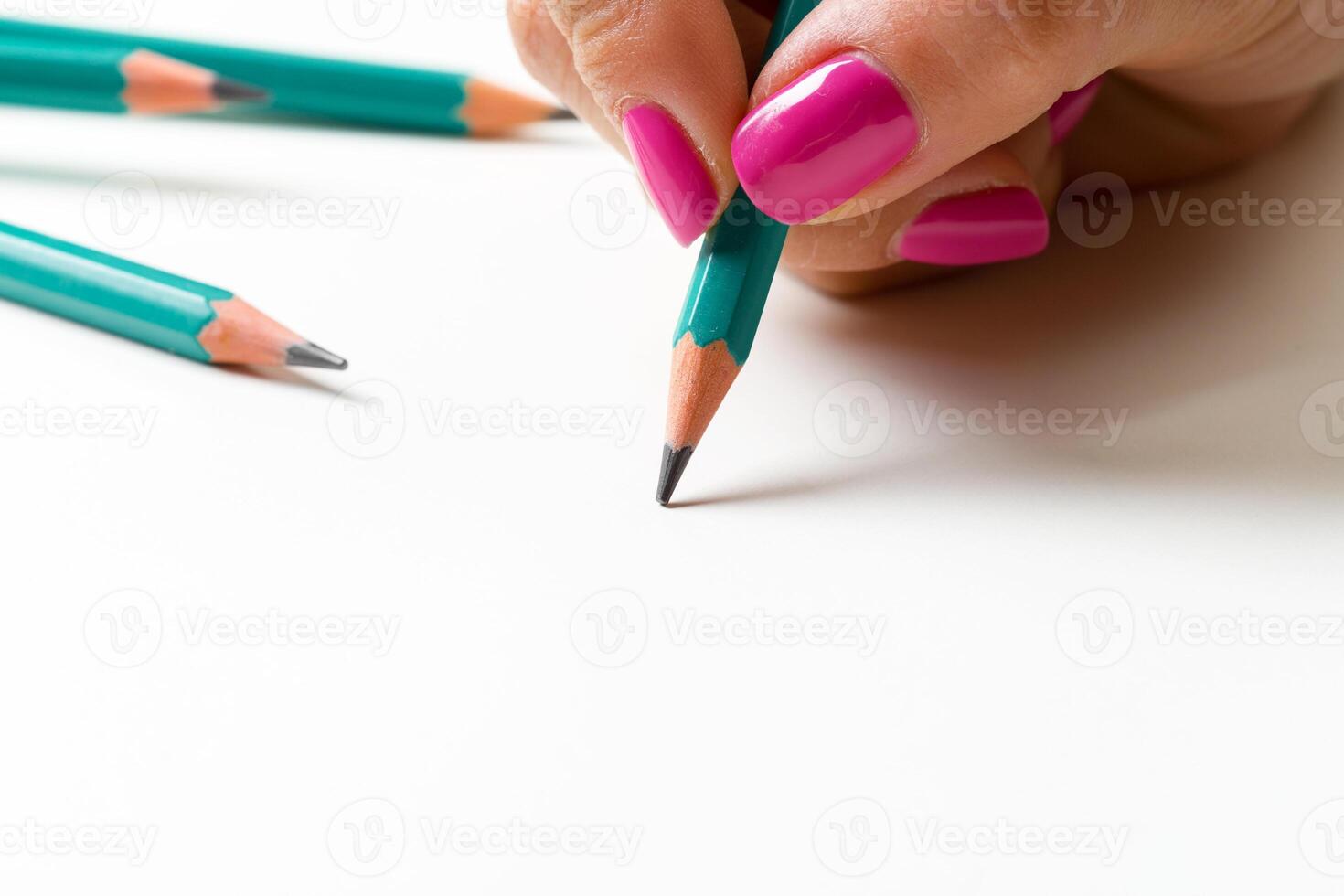 Woman's hand with a pencil photo