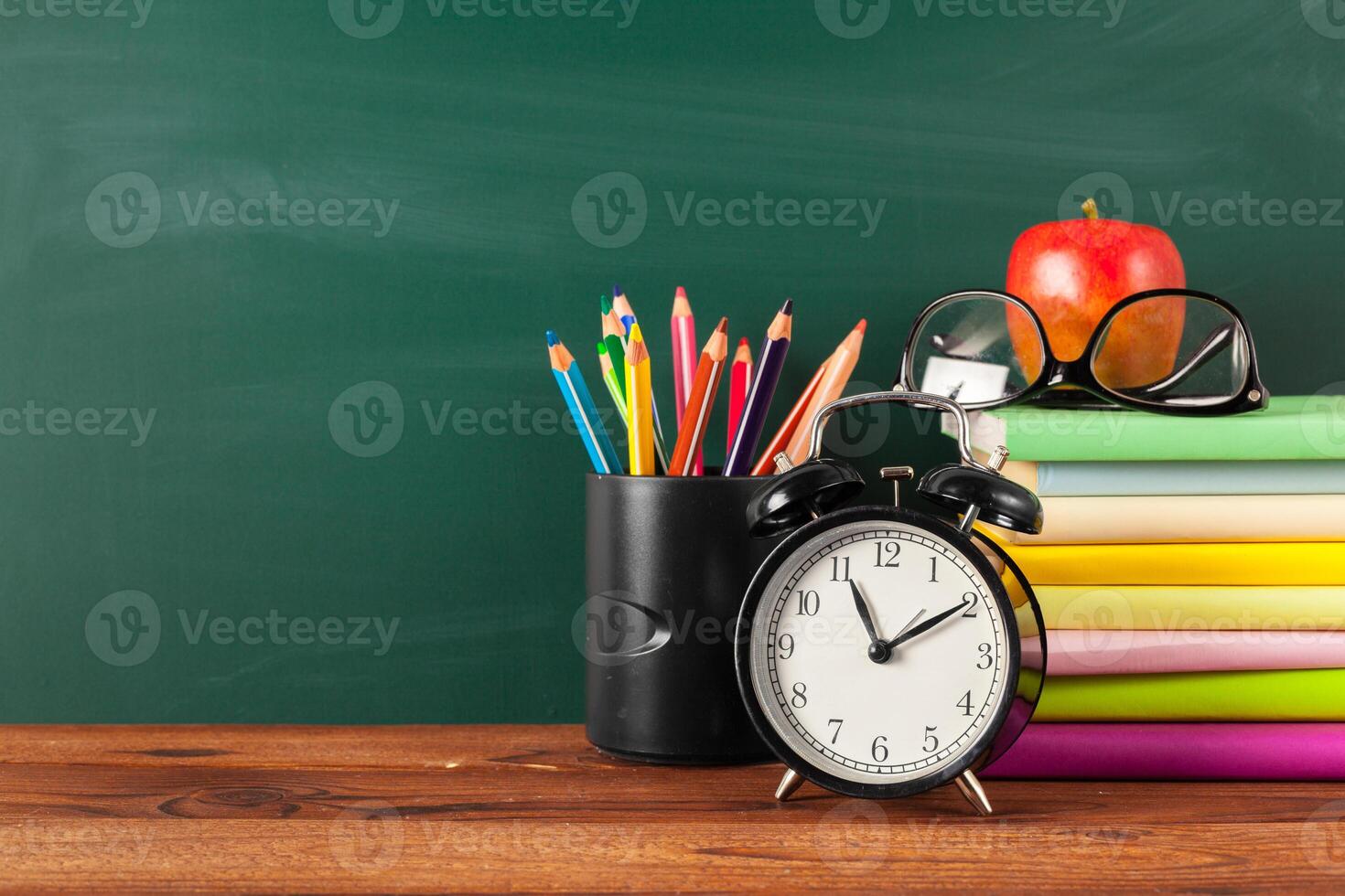 back to school - apple and books with pencils and blackboard photo