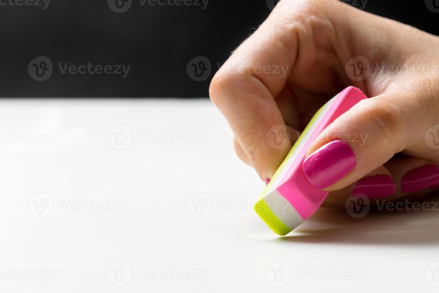 side view of hand with rubber eraser photo